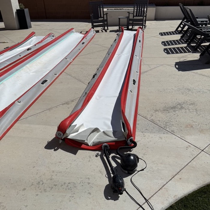 A long Swole Slide rolled out on a driveway
